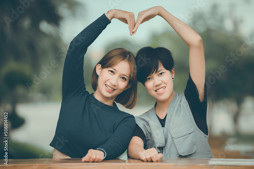 Couple of girl with girl,LGBT Pride month concept,Asian Handsome male make up and wear woman cloth,Gay Freedom Day,Portrait of Non-binary on white background photo