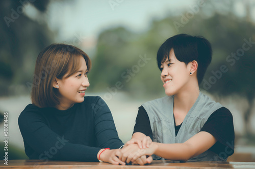 Couple of girl with girl,LGBT Pride month concept,Asian Handsome male make up and wear woman cloth,Gay Freedom Day,Portrait of Non-binary on white background photo