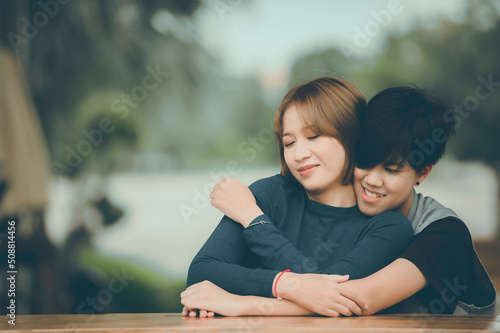 Couple of girl with girl,LGBT Pride month concept,Asian Handsome male make up and wear woman cloth,Gay Freedom Day,Portrait of Non-binary on white background photo