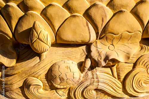 Buddism style  lotus and turtle 3D textured Brick wall at Wat Sisrathong temple, Nakhon Pathom City, Thailand