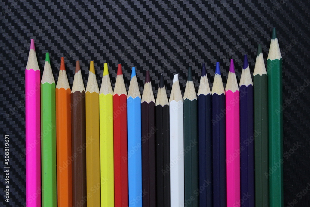 Color pencils on black table sheet