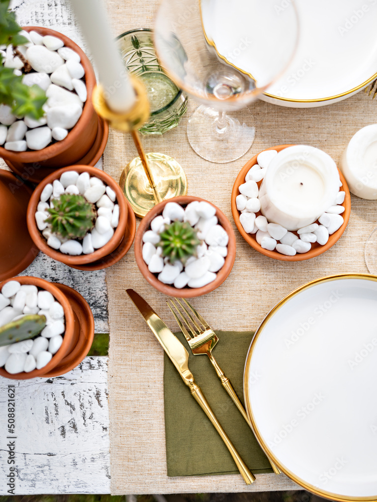Inspirational image of luxury table setting in tropical style with candles, avocado and lime decoration. Table served for romantic dinner or event. Outdoor catering or dining. Selective focus. Inspirational image of luxury table setting in tropical style with candles, avocado and lime decoration. Table served for romantic dinner or event. Outdoor catering or dining. Selective focus.