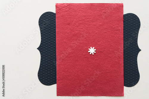 paper asterisk on red and black background