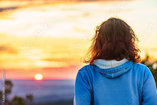Woman enjoying sunset view.