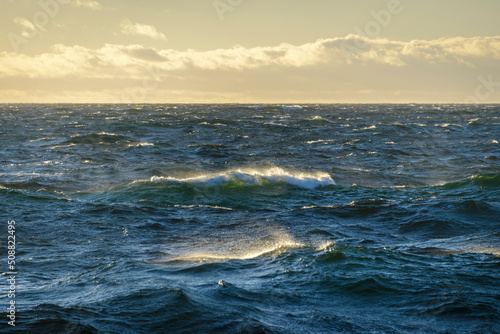 Beautiful seascape - waves and sky with clouds with beautiful lighting. Golden hour. © Alexey Seafarer