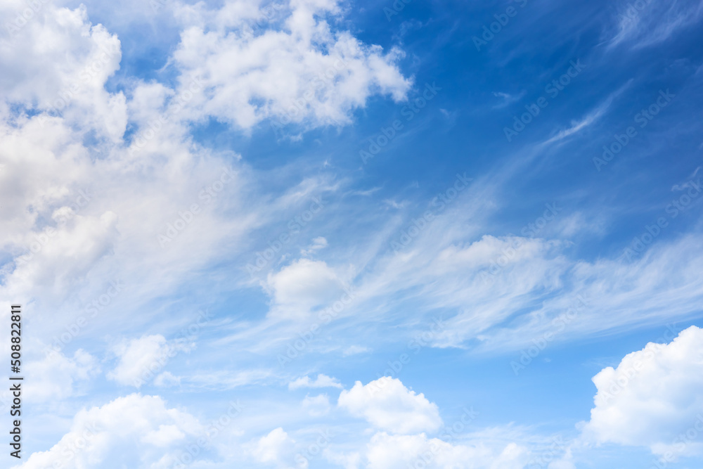 Soft and fluffy clouds formation on the bright sunny blue sky. Nature abstract background. Fresh air, weather and freedom concept Soft and fluffy clouds formation on the bright sunny blue sky. Nature abstract background. Fresh air, weather and freedom concept
