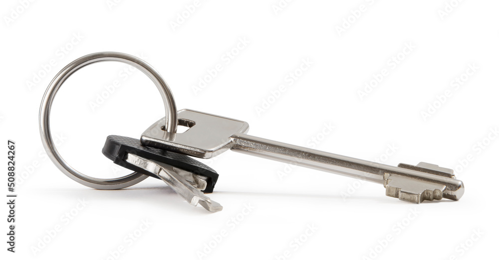 Closeup of isolated keys on white background, image useful for concept to real estate sale and buy, car services, security home systems with burglar armored doors or turnkey service solutions Closeup of isolated keys on white background, image useful for concept to real estate sale and buy, car services, security home systems with burglar armored doors or turnkey service solutions