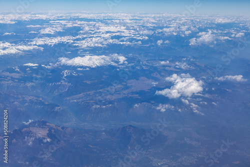 Mountain range view from above . Aerial view of peaks covered by snow 