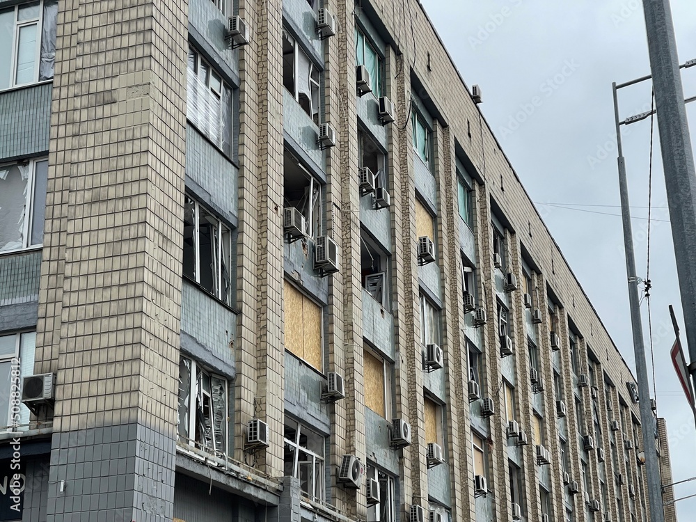 Windows broken in a house after bomb shelling in warzone city