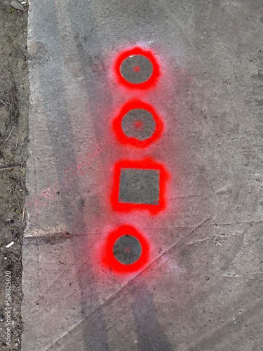 Vertical top view shot of neon spray painted shapes on the concrete