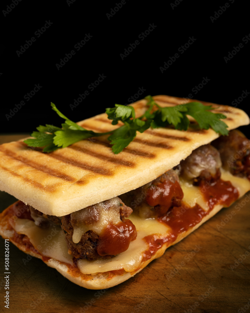 Meatball sandwich with marinara sauce, mozzarella and parsley Meatball sandwich with marinara sauce, mozzarella and parsley
