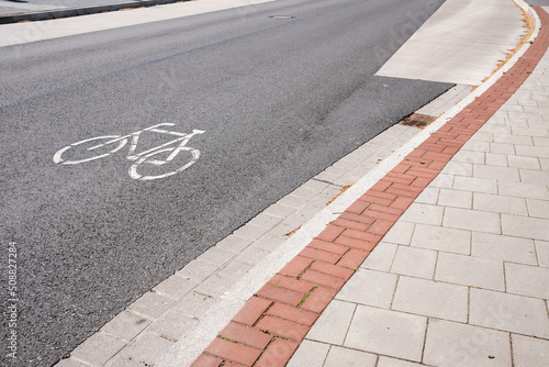 Sign printed on the road allowing cycling, next to the sidewalk. Security concept.