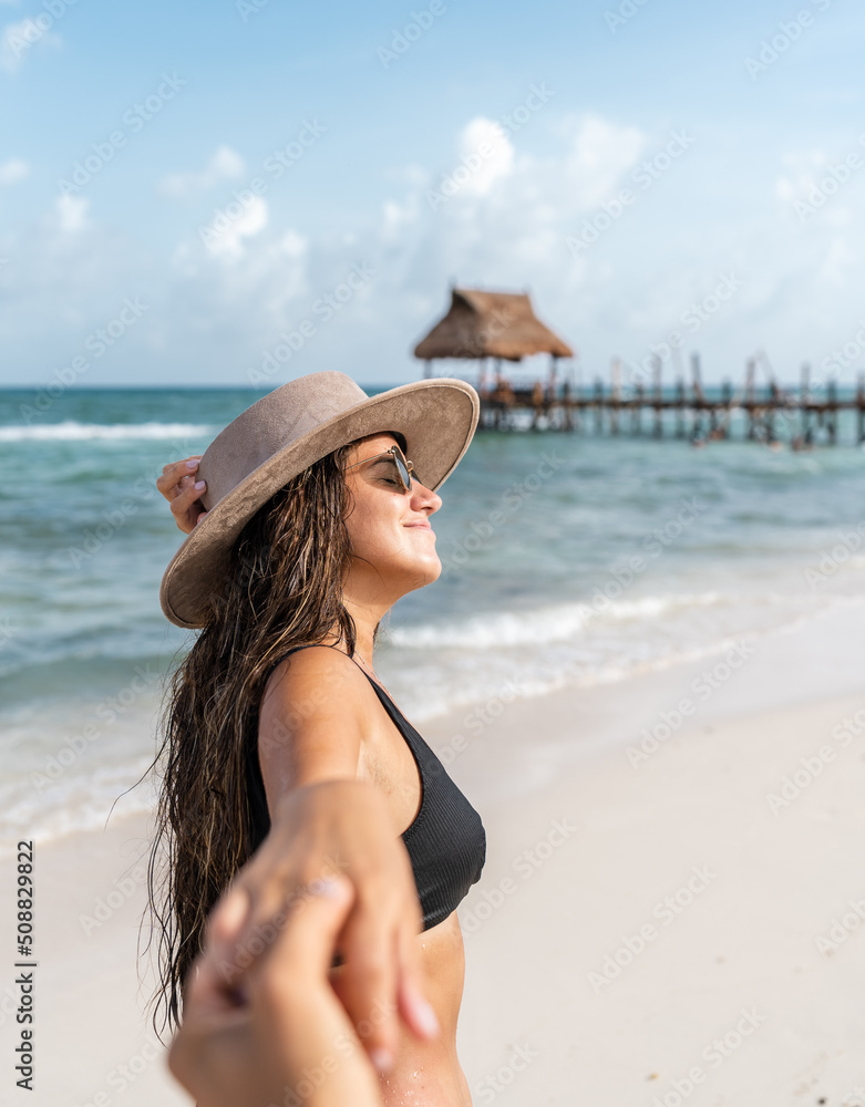young hispanic woman grabs her partner's hand and smile - follow me concept young hispanic woman grabs her partner's hand and smile - follow me concept