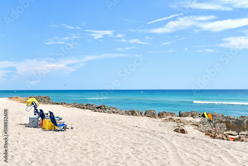 Beachchairs set up for a Summer beach day in Stuart Rocks Beach in Stuart, Florida in Martin County photo