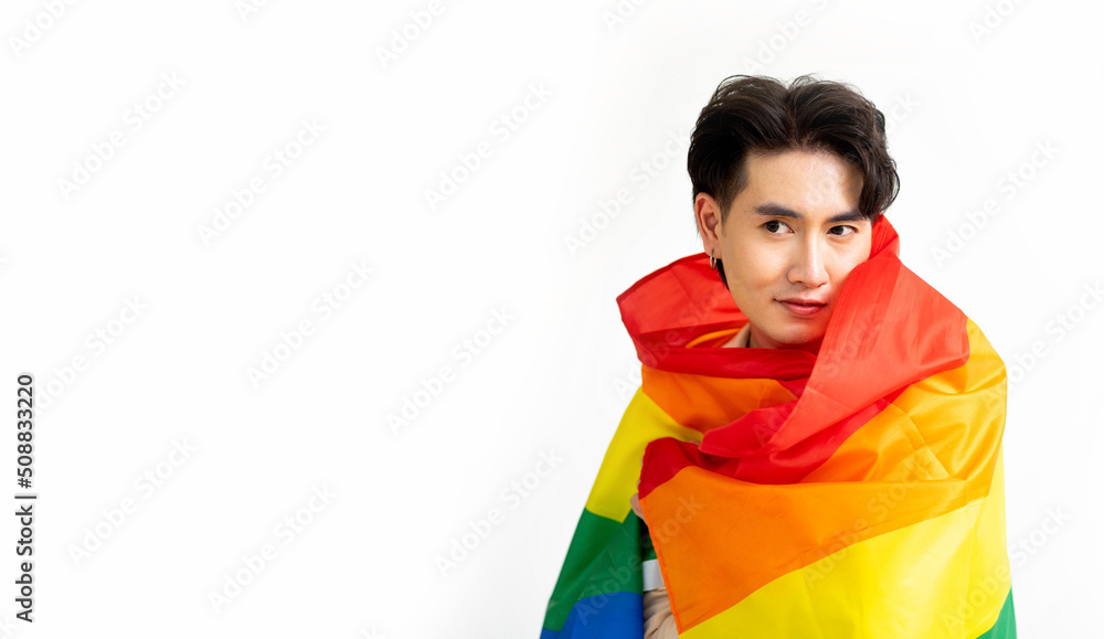 Smiling transgender man with pride flag isolated on white background with copy space. People lifestyle fashion lgbtq concept. Smiling transgender man with pride flag isolated on white background with copy space. People lifestyle fashion lgbtq concept.