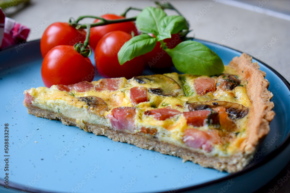 Quiche Lorraine Tart. Quiche is a tart consisting of pastry crust filled with eggs custard and pieces of cheese, bacon, and asparagus.