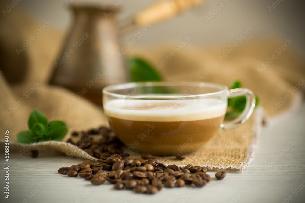 Cup of coffee latte with heart shape and coffee beans Cup of coffee latte with heart shape and coffee beans