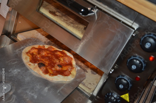 Margherita Pizza cooking in an electric pizza oven, Italian recipe