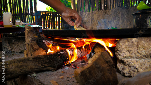 tortilla in a clay comal cooked with firewood photo