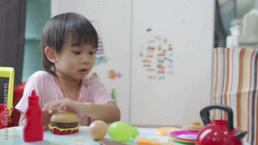 Little boy chef cooking hamburger on the table, Kids play and cook at school. Little boy chef cooking hamburger on the table, Kids play and cook at school.