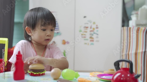 Little boy chef cooking hamburger on the table, Kids play and cook at school.