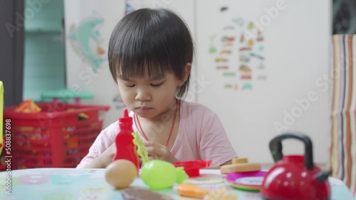 Little boy chef cooking hamburger on the table, Kids play and cook at school.