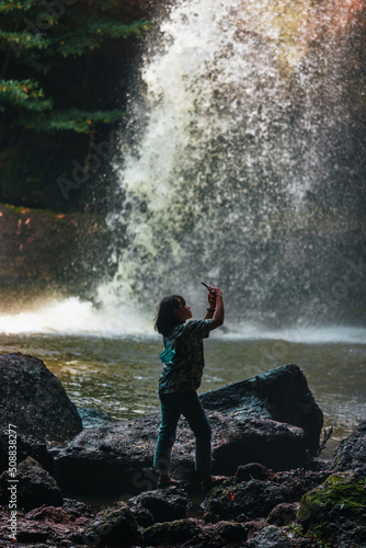 People are in the forest watching waterfalls and watching the beautiful nature playing in the water and relaxing on vacation. At Khao Yai National Park, Thailand, 16-05-2022