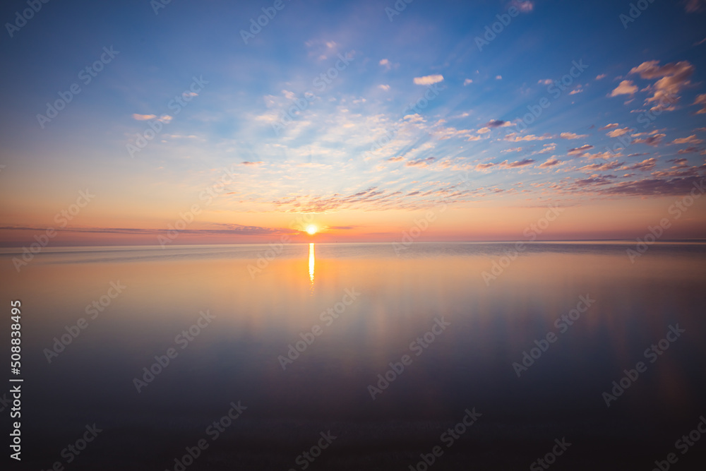 Amazing sunrise over the beach in Chalupy. Seascape with breakwater
