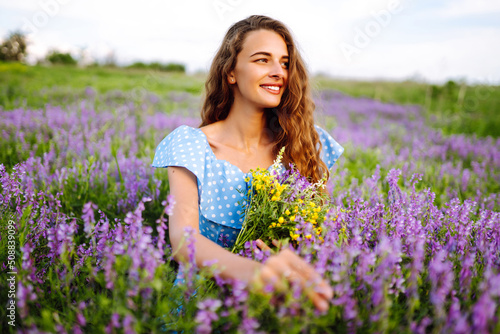 Beautiful woman in the blooming field. Nature, vacation, relax and lifestyle. Summer landscape.