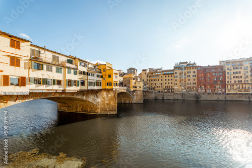 Sunset view on famous Old bridge called Ponte Vecchio on Arno river in Florence, Italy. Concept of traveling Italy, visiting italian landmarks