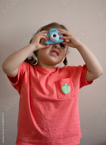 little child looking through camera