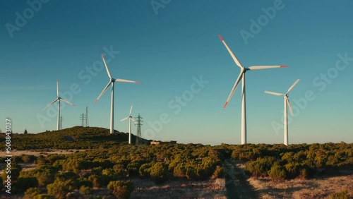 rotation wind turbine wind mills on the hill blue sky background green energy packshot