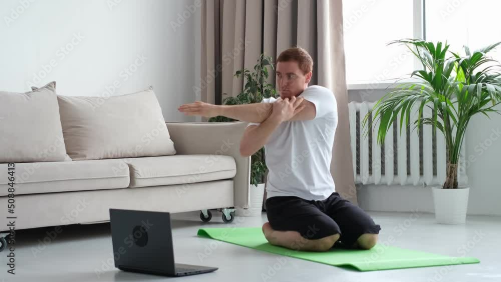 Self-care during stay at home. Fitness training, stretching exercises online men at home with laptop. guy lying on fitness mat online yoga lessons blank laptop screen. Self-care during stay at home. Fitness training, stretching exercises online men at home with laptop. guy lying on fitness mat online yoga lessons blank laptop screen.