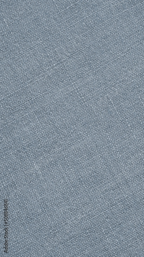 Light blue woven surface closeup. Linen textile texture. Fabric net vertical background. Textured braided len backdrop. Mobile phone wallpaper. Macro