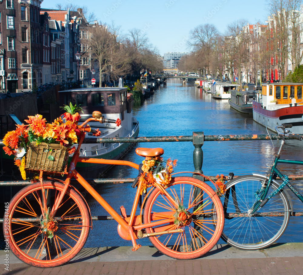 Amsterdam symbolic bright decorated bike with flowers and canal in background