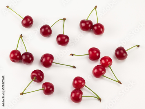 Fresh red sour cherries isolated on white background. Top view. Flat lay pattern.