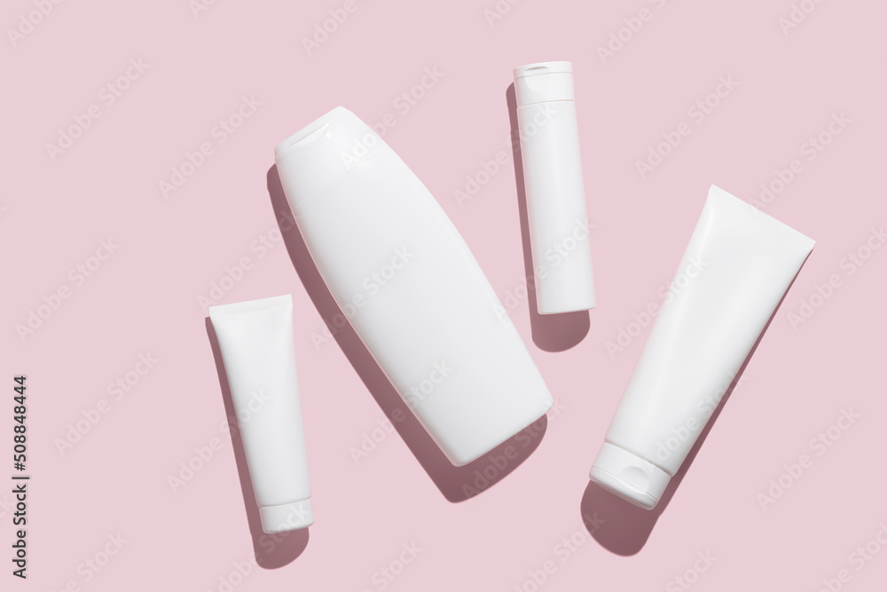 Cosmetic products collection. Blank white cosmetic bottle/tube on pink background. Branding mock-up for lotion, cream, gel, foam, soap or shampoo. Minimal style. Beauty blogger concept Cosmetic products collection. Blank white cosmetic bottle/tube on pink background. Branding mock-up for lotion, cream, gel, foam, soap or shampoo. Minimal style. Beauty blogger concept