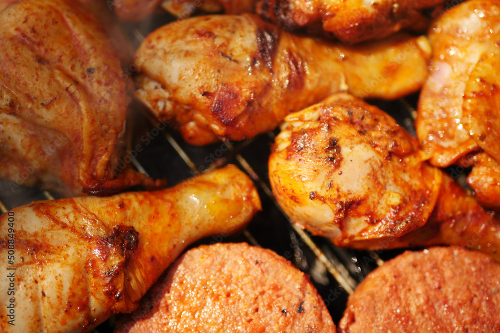 Close up roasted chicken legs. Summer barbecue cooking. Outdoor grilling food