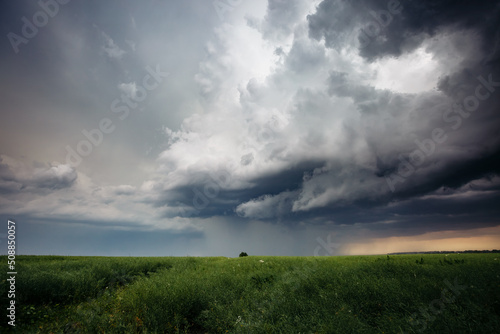 Dark ominous clouds in front of a hurricane over farmland.