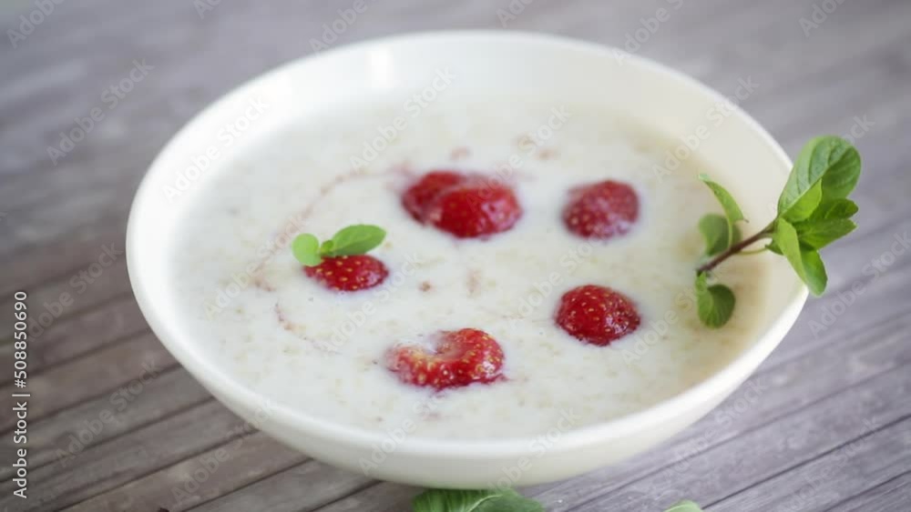 sweet milk oatmeal with strawberries in a plate sweet milk oatmeal with strawberries in a plate