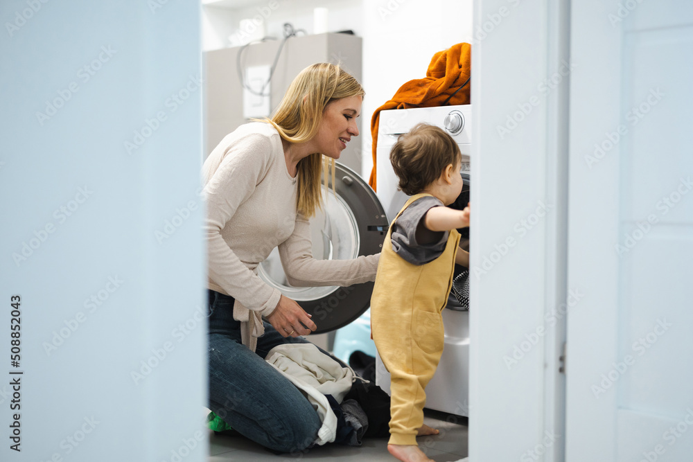 Mother and son loading washing machine
Mother and son loading washing machine