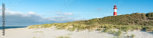 Panoramic view of a lighthouse standing near the coast of Sylt, North Sea, Germany 