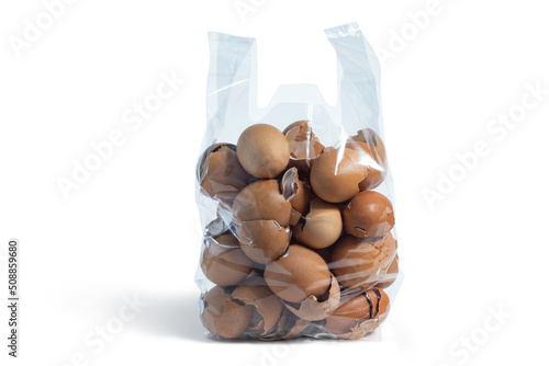 Eggshells in a plastic container to be used as organic fertilizer on white background