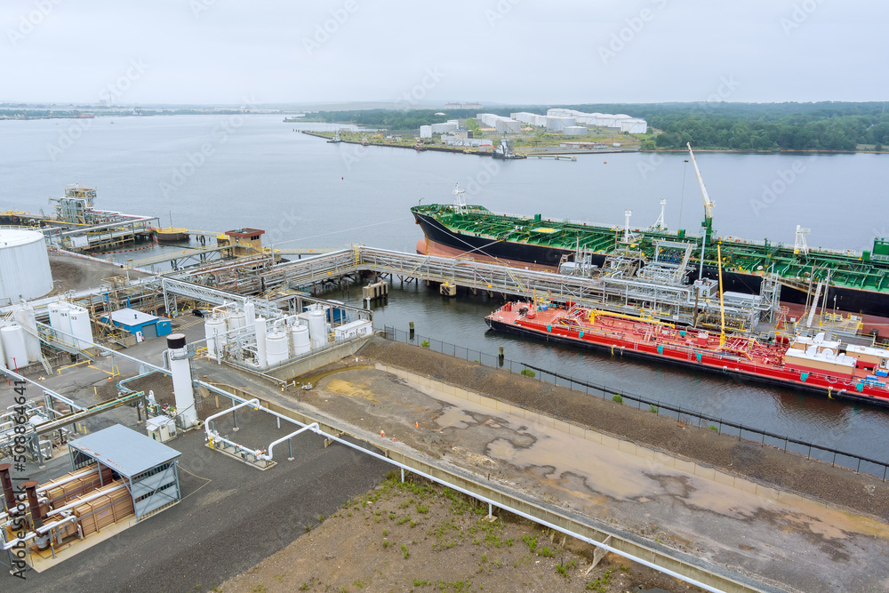 Aerial view at oil terminal commercial port for transfer with logistic industrial crude oil fuel tanker ship
