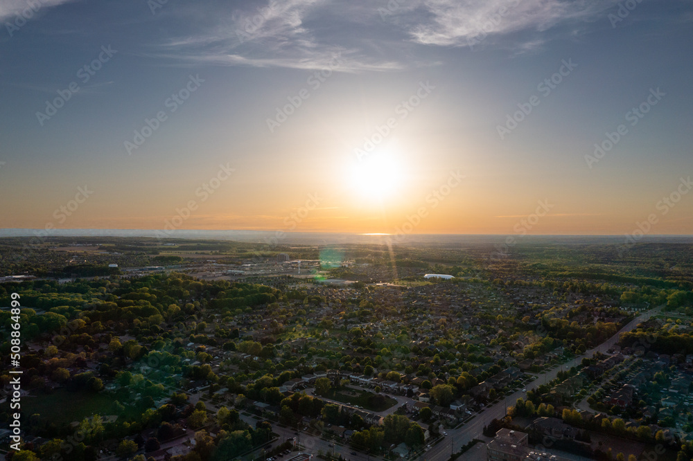 Barrie suburbs sunset drone view  sun shining 