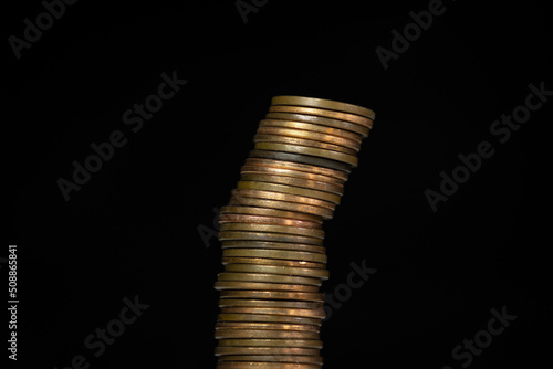 Stack of coins about to fall over