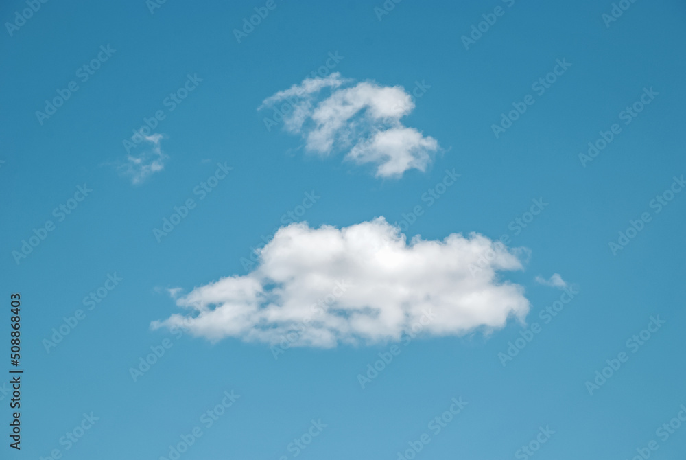 Blue summer sky with few sparse clouds, idyllic cloudscape with copy space Blue summer sky with few sparse clouds, idyllic cloudscape with copy space