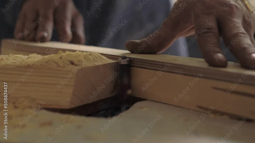Slow motion the woodworking milling cutter removes chamfers from the edge of a board with a large amount of sawdust. Carpenter in the workshop, makes furniture parts in natural light. Carpentry tools Slow motion the woodworking milling cutter removes chamfers from the edge of a board with a large amount of sawdust. Carpenter in the workshop, makes furniture parts in natural light. Carpentry tools