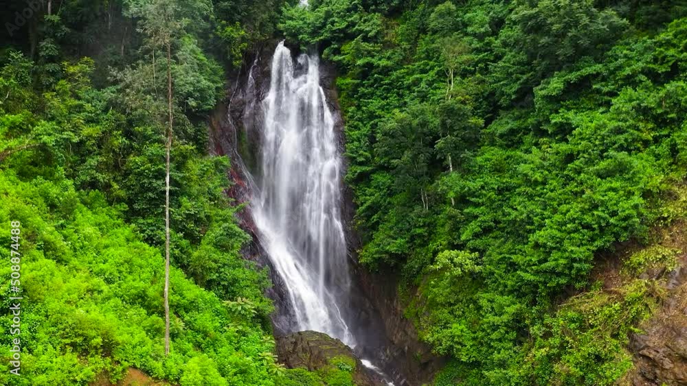Waterfall among tropical jungle with green plants and trees. Mohini Falls. Sri Pada, Sri Lanka. Waterfall among tropical jungle with green plants and trees. Mohini Falls. Sri Pada, Sri Lanka.