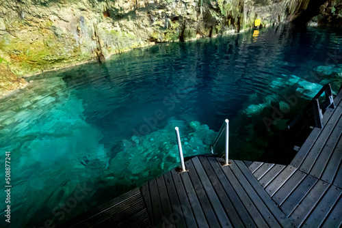 Canvas Print beautiful natural pool of crystal clear water formed a rocky cave with stalagmit